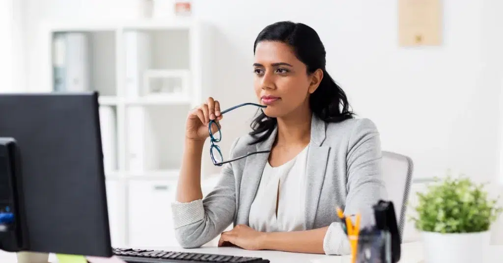 A professional administrator reviewing Medicaid reimbursement details for a behavioral health residential facility on her computer.