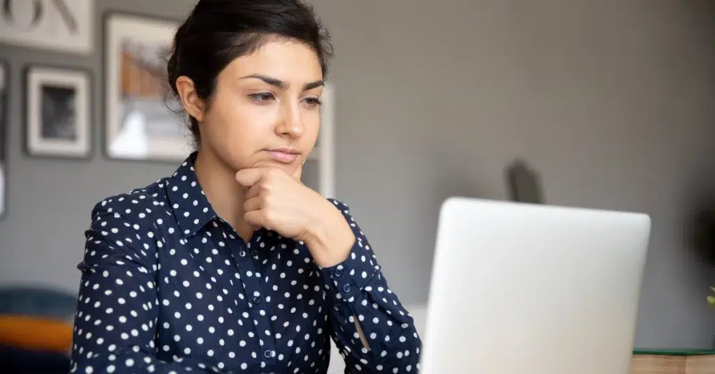 Professional reviewing information about residential mental health facilities on a laptop.