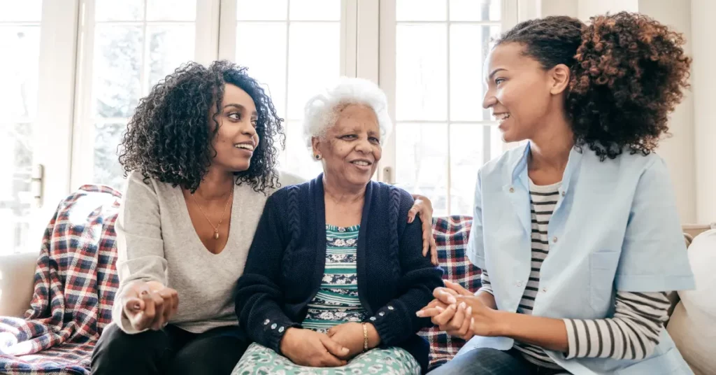 Counselor sitting with elderly client and family member